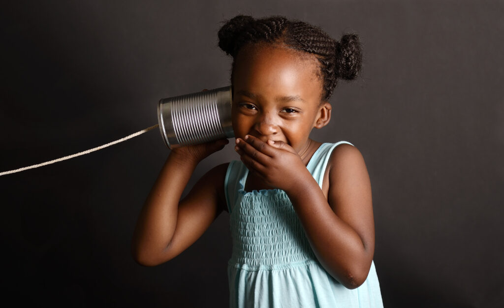 Black girl with tin can and string phone